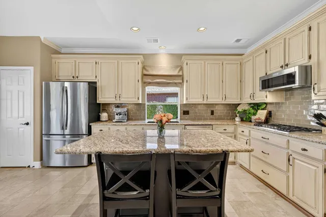 a dining room with furniture a chandelier and a rug
