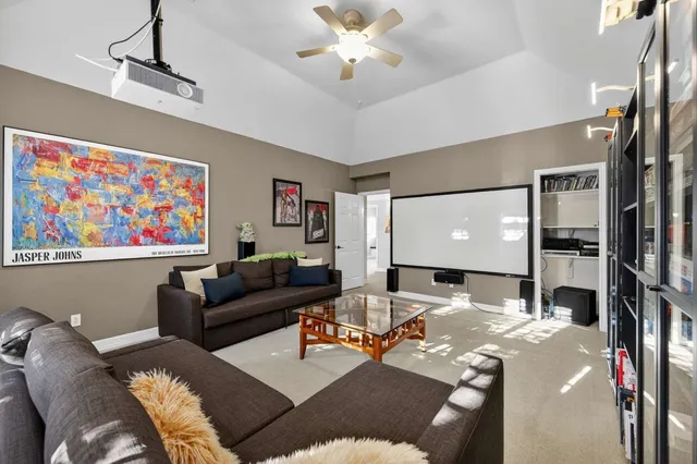 a living room with furniture a bookshelf and a chandelier
