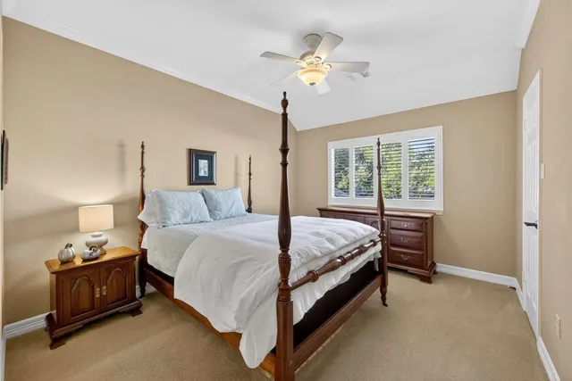 a en suite bathroom with a granite countertop sink and a mirror
