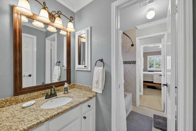 a bedroom with a bed couches and window