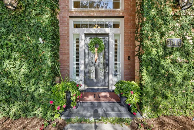 a view of a large building with a big yard and large trees