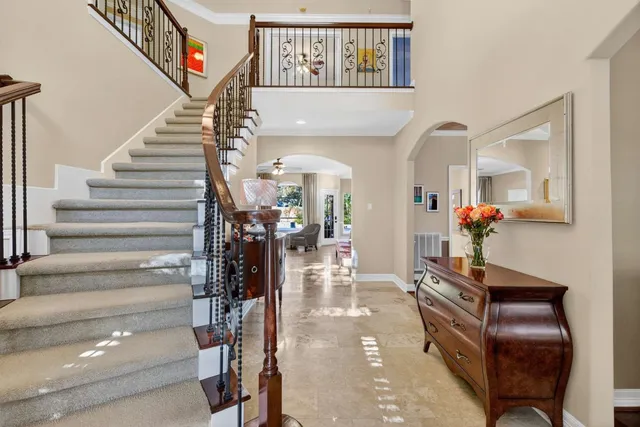 a view of a hallway to a livingroom with furniture