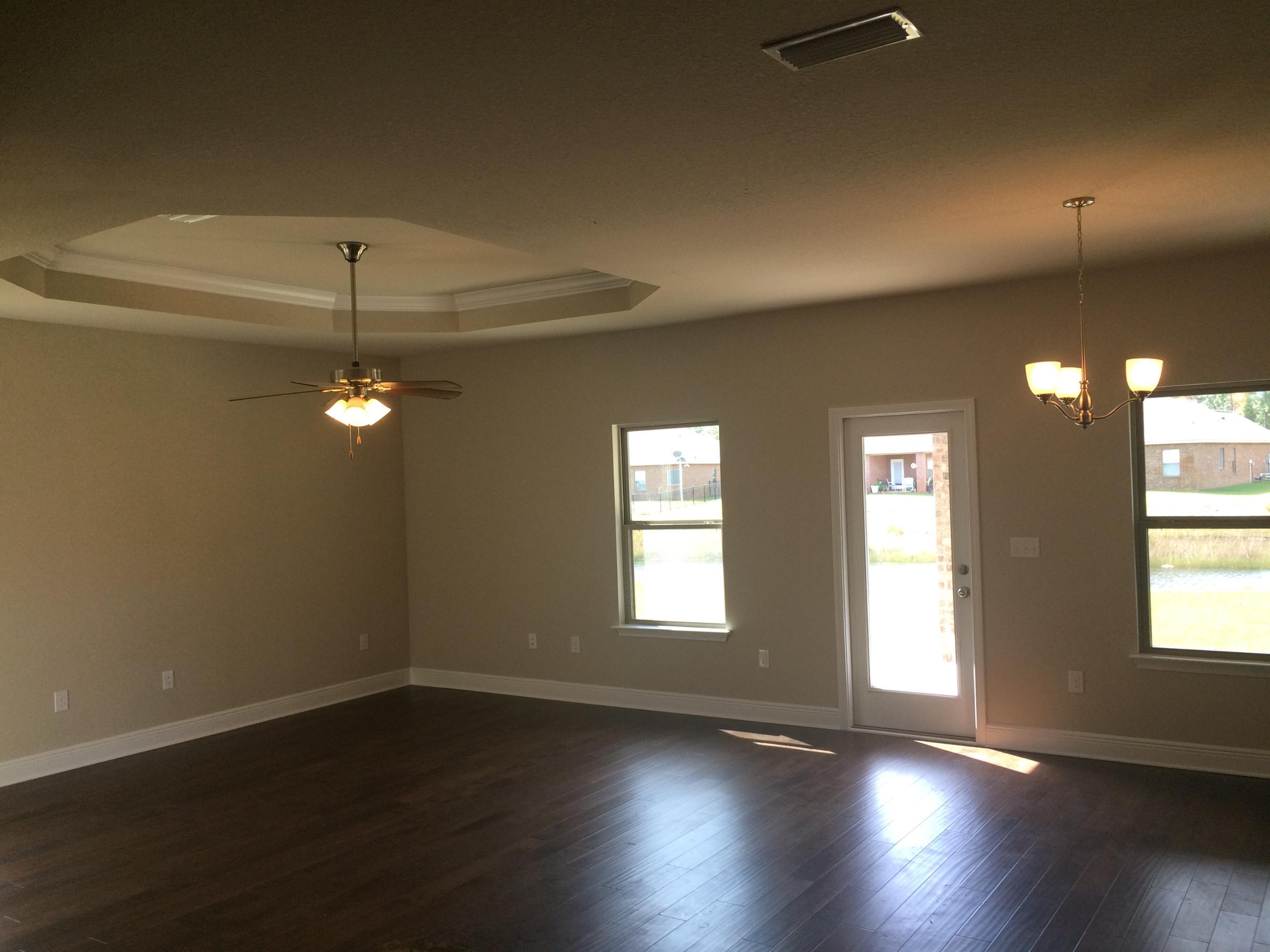 320 Pin Oak Loop Santa Rosa Beach, FL 32459 - Photo 8 of 20 an empty room with wooden floor and windows