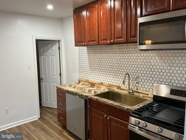 a kitchen that has a sink and a stove