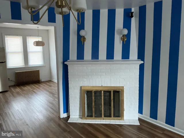 a view of a livingroom with wooden floor and stairs