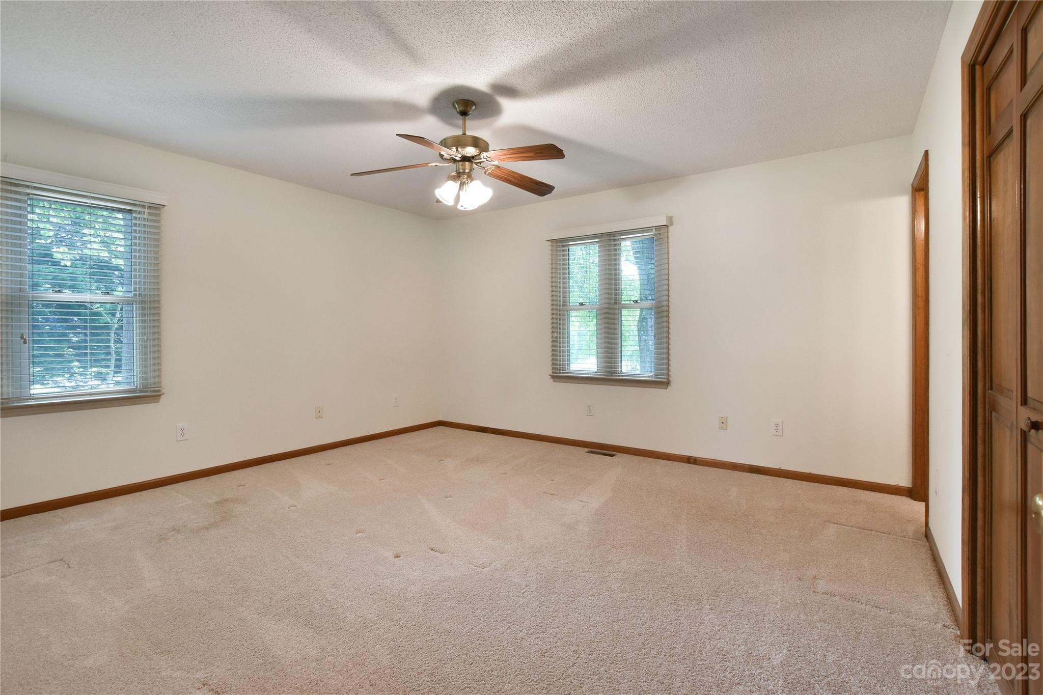 3075 Stoneybrook Drive Fort Mill, SC 29708 - Photo 18 of 31 an empty room with windows and fan