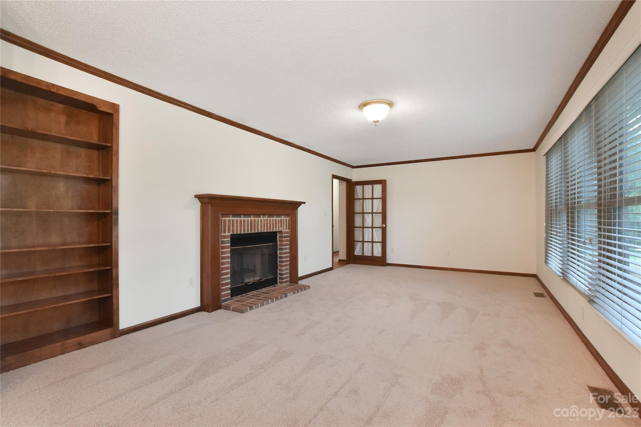 3075 Stoneybrook Drive Fort Mill, SC 29708 - Photo 5 of 31 a view of an empty room with a fireplace and a window
