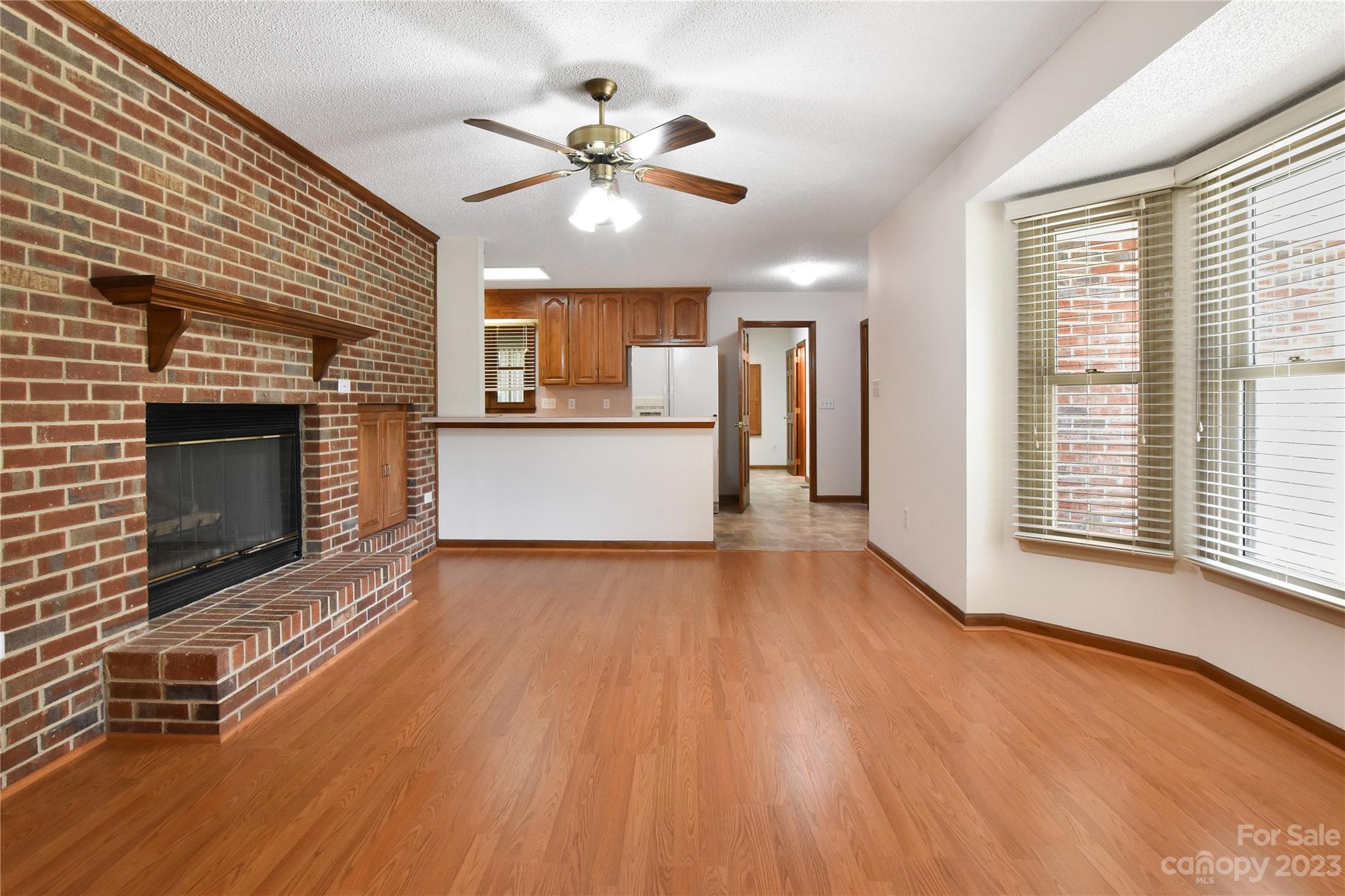 3075 Stoneybrook Drive Fort Mill, SC 29708 - Photo 9 of 31 a view of an empty room with wooden floor fireplace and a window