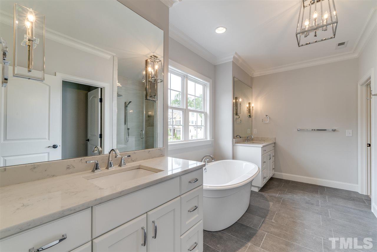 113 Roseroot Court Holly Springs, NC 27540 - Photo 10 of 25 a bathroom with a toilet sink and mirror