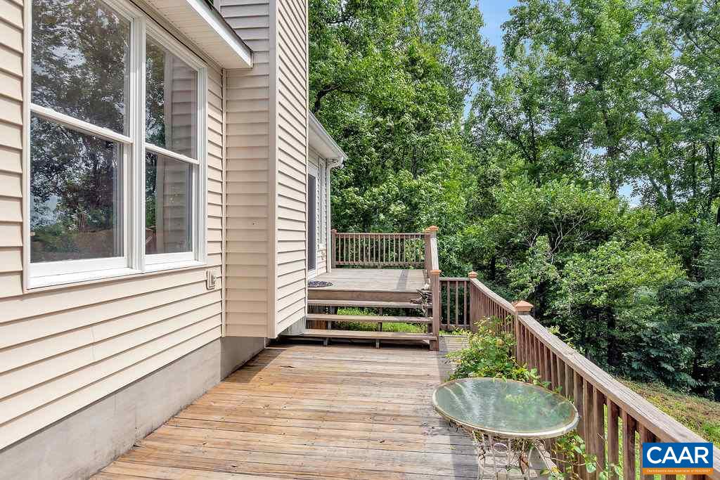 343 Wyland Road Buckingham, VA 23921 - Photo 24 of 46 a balcony with wooden floor table and chairs