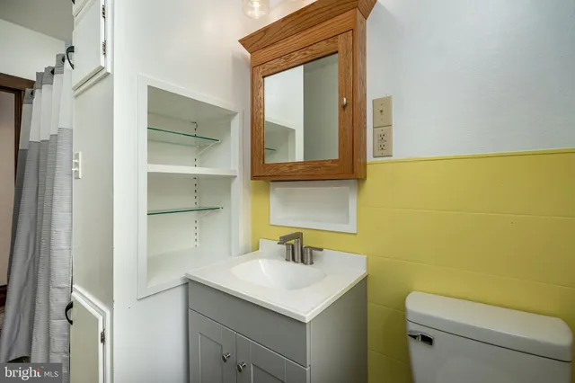 a bathroom with a sink toilet and vanity
