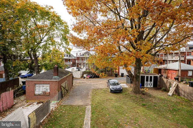 a front view of a building with a garden