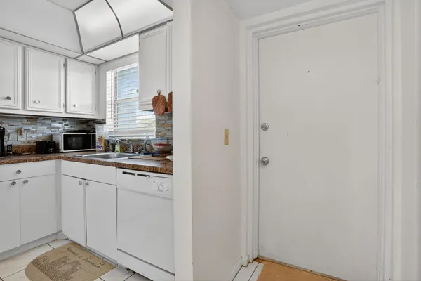 a kitchen with refrigerator and cabinets