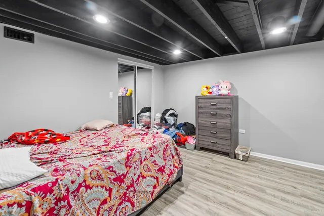 a bedroom with bed and a chandelier