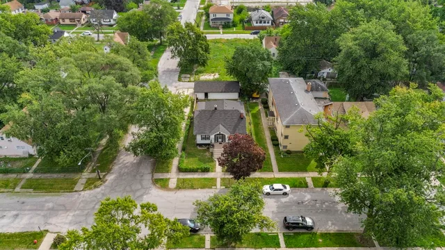 an aerial view of a house with a yard and lake view