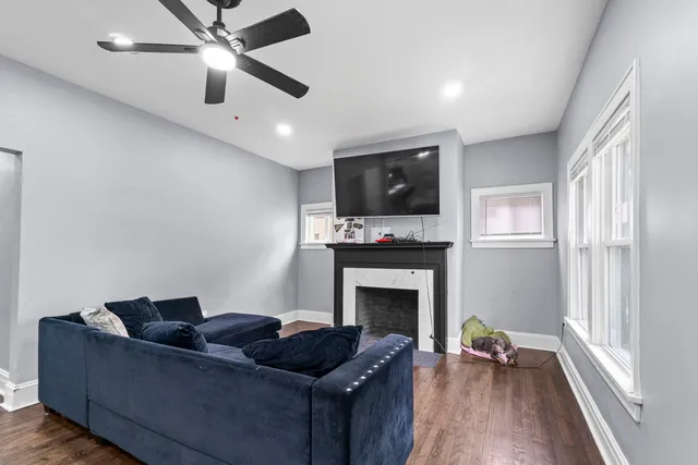 a living room with furniture a flat screen tv and a fireplace