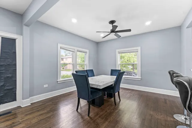 a view of a dining room with furniture window and wooden floor