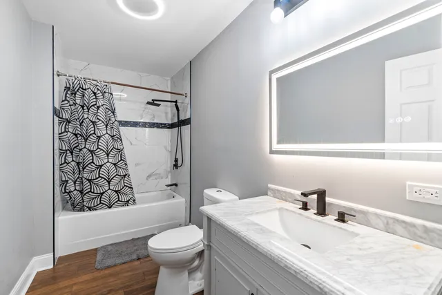 a bathroom with a sink toilet and shower