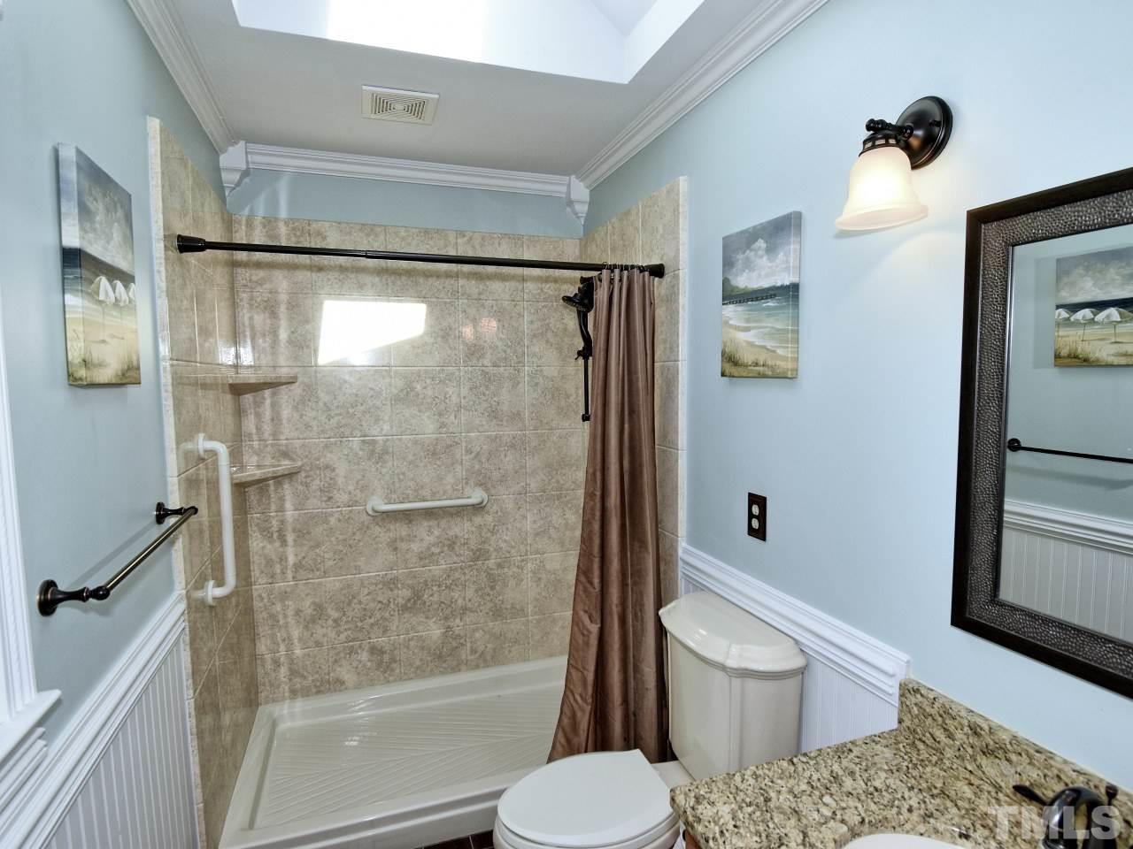 5708 Hayloft Circle Raleigh, NC 27606 - Photo 16 of 27 a bathroom with a shower and a toilet