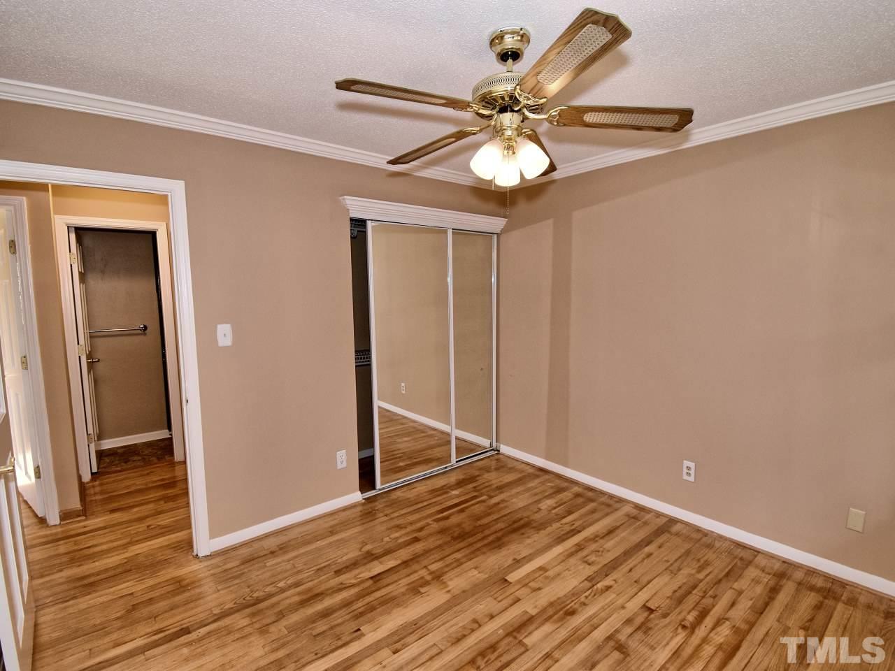 5708 Hayloft Circle Raleigh, NC 27606 - Photo 18 of 27 a view of a room with wooden floor and a ceiling fan