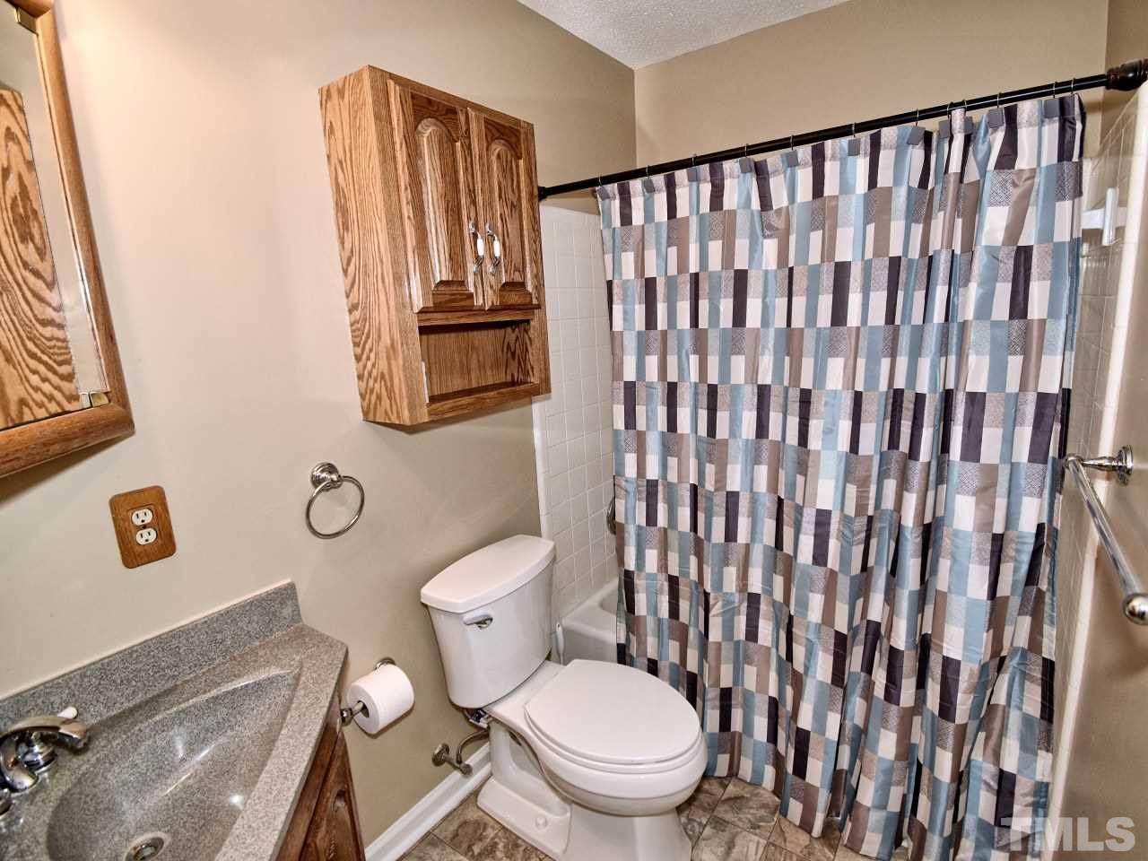 5708 Hayloft Circle Raleigh, NC 27606 - Photo 20 of 27 a white toilet sitting next to a shower curtain