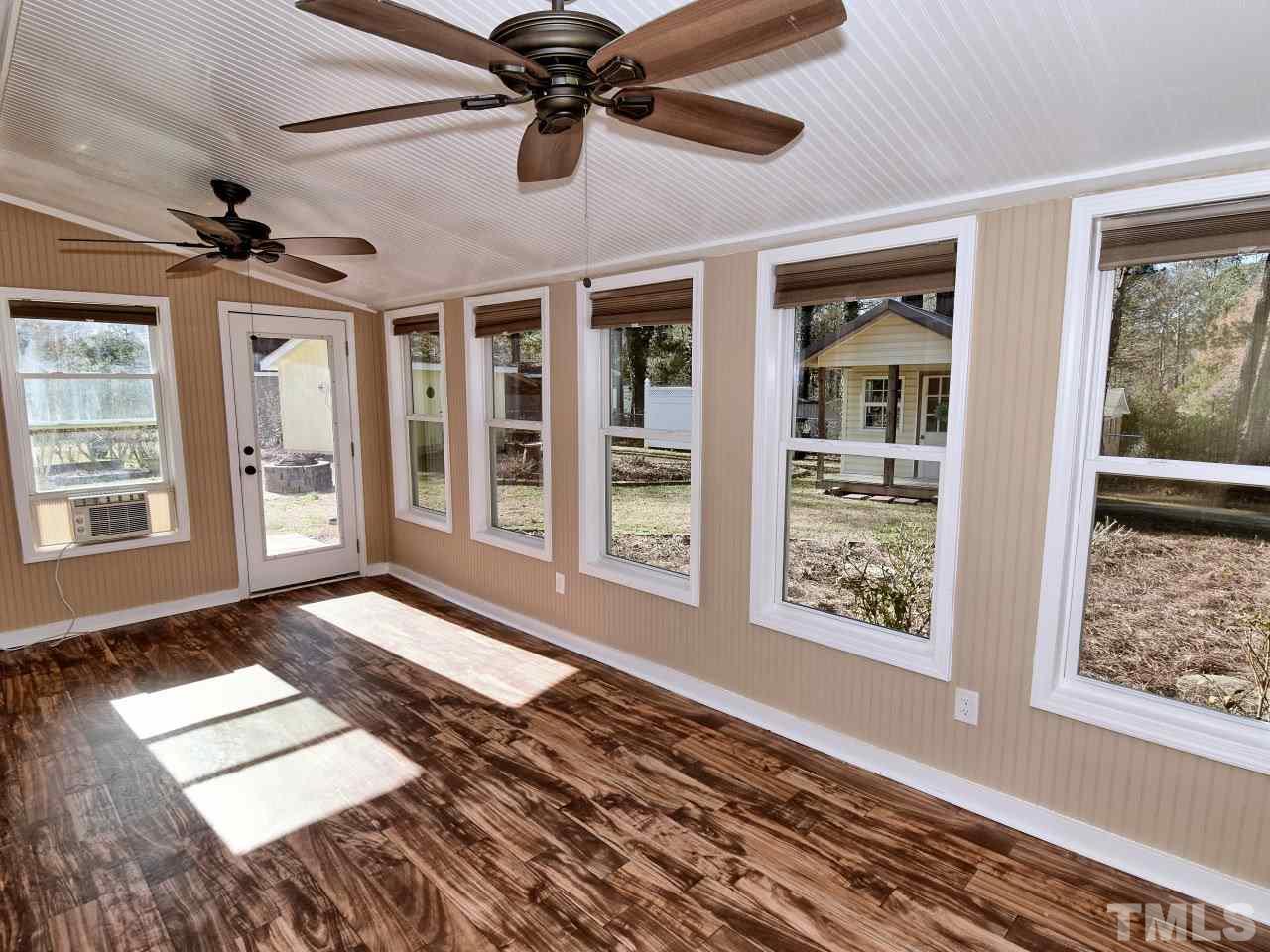 5708 Hayloft Circle Raleigh, NC 27606 - Photo 21 of 27 a view of an empty room with a window and a ceiling fan