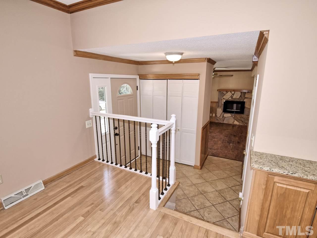 5708 Hayloft Circle Raleigh, NC 27606 - Photo 4 of 27 a view of a hallway with wooden floor and staircase
