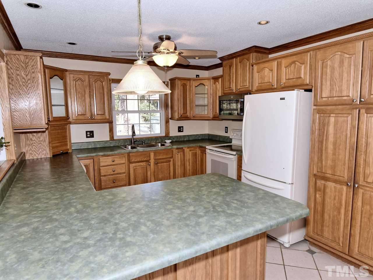 5708 Hayloft Circle Raleigh, NC 27606 - Photo 8 of 27 a kitchen with stainless steel appliances granite countertop a sink a refrigerator and a stove
