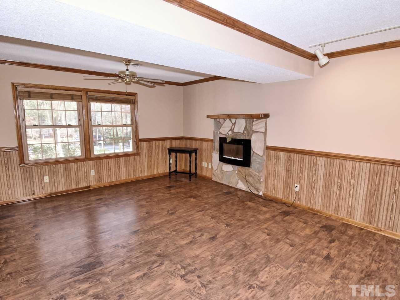5708 Hayloft Circle Raleigh, NC 27606 - Photo 10 of 27 a view of an empty room with a fireplace and a window