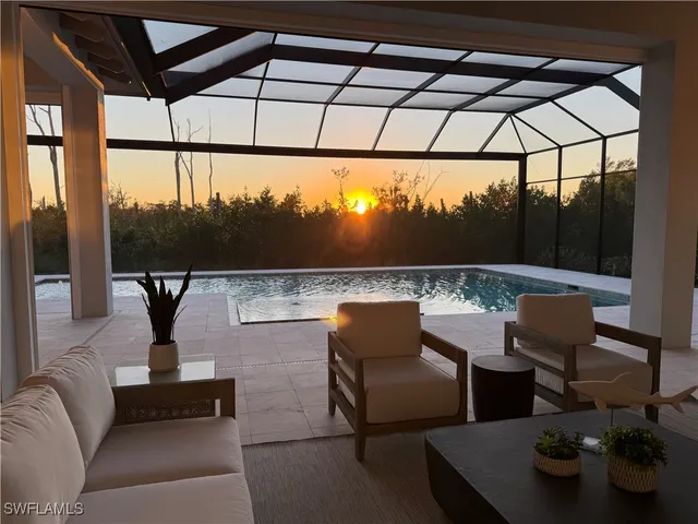 a living room with furniture and a lamp