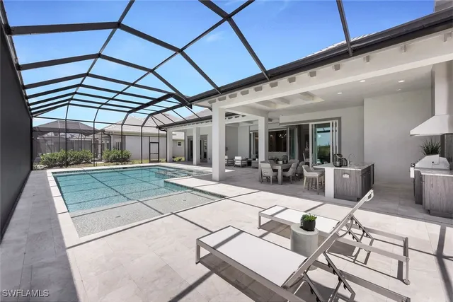 a view of a patio with table and chairs under an umbrella