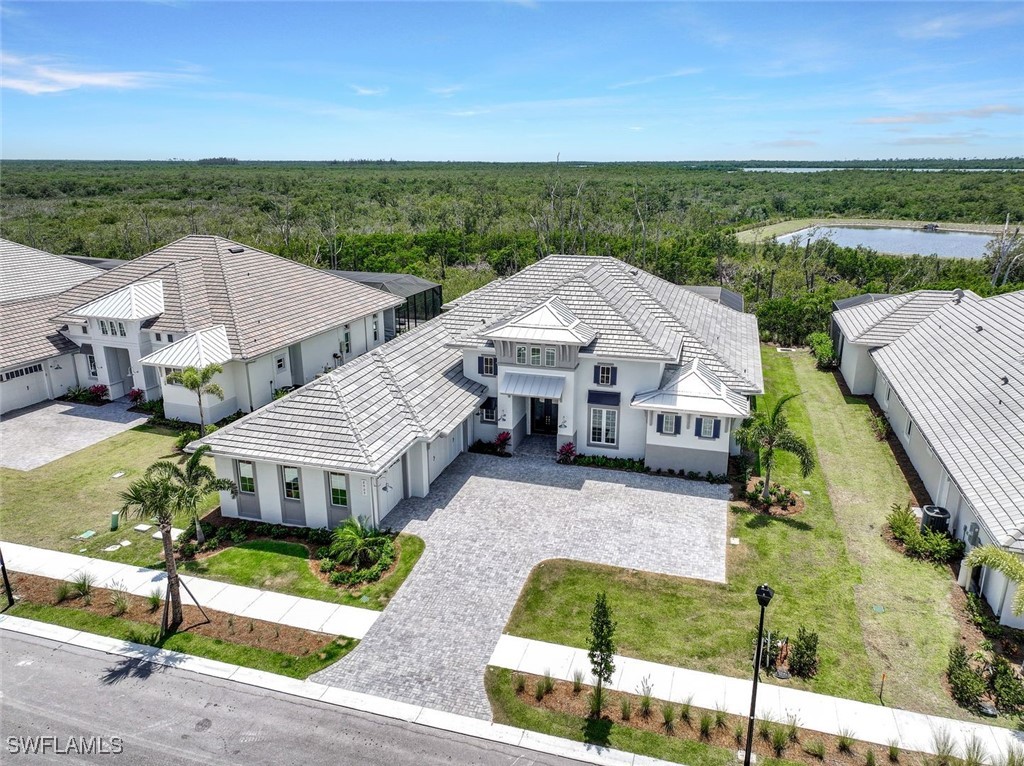 8903 Nevis Way Naples, FL 34112 - Photo 26 of 36 an aerial view of a house with a garden and plants
