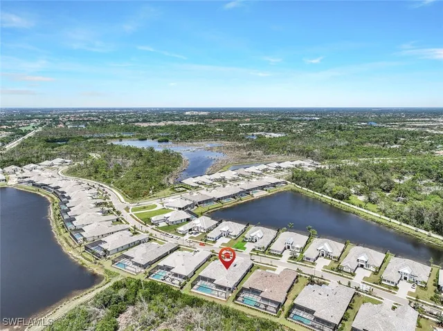 an aerial view of lake and residential houses with outdoor space