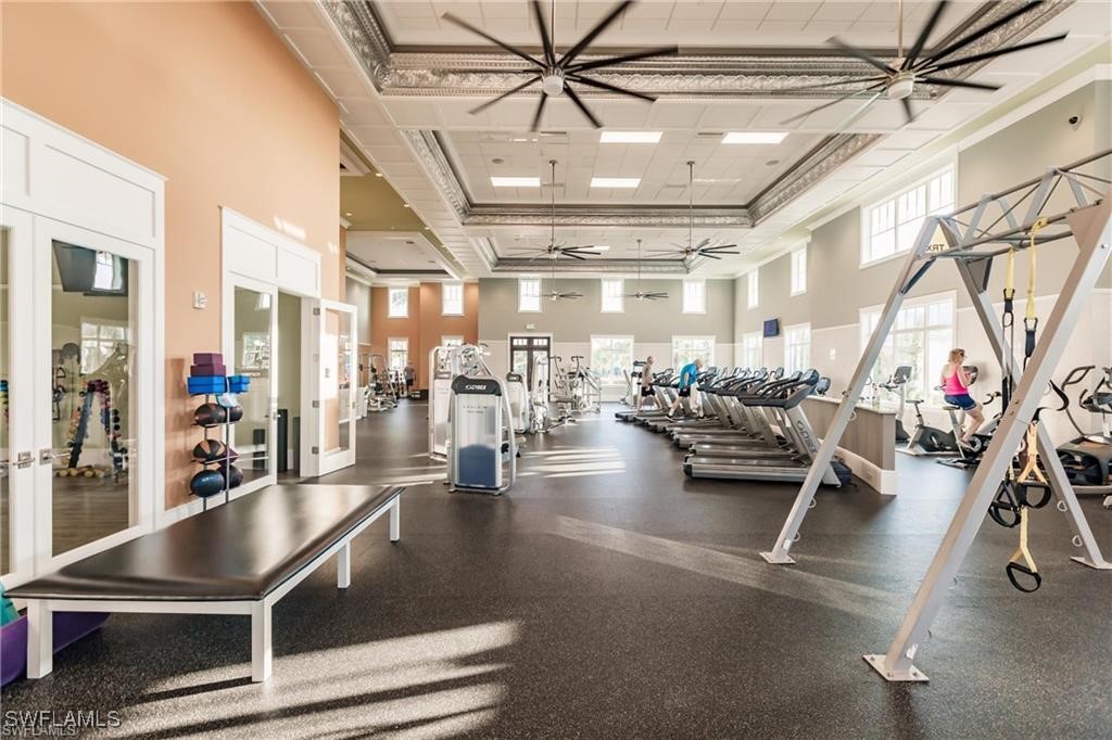 8903 Nevis Way Naples, FL 34112 - Photo 31 of 36 a gym room with lots of furniture and lots of gym equipment