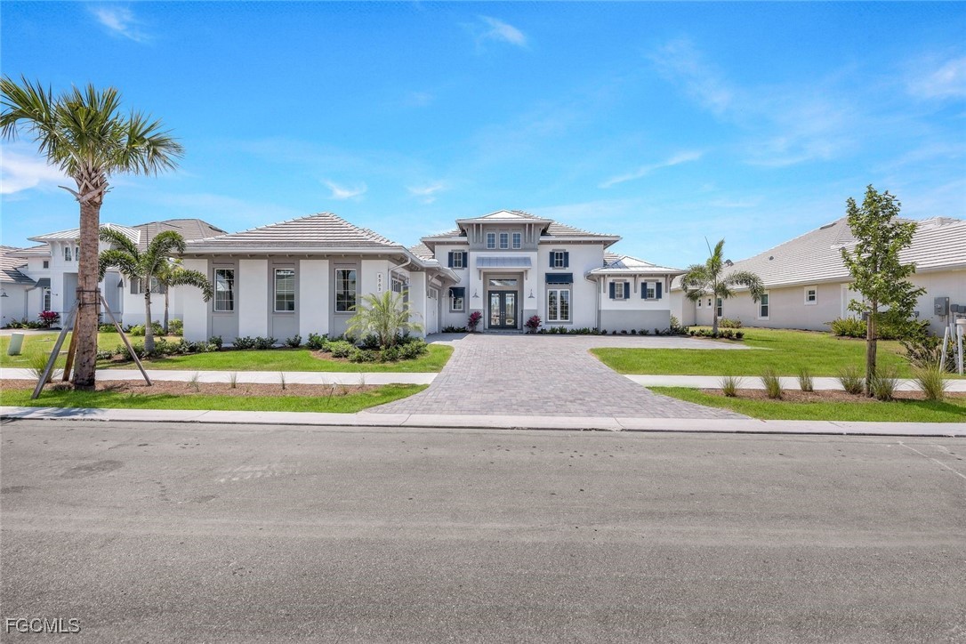 8903 Nevis Way Naples, FL 34112 - Photo 36 of 36 a view of a house with a big yard and palm trees