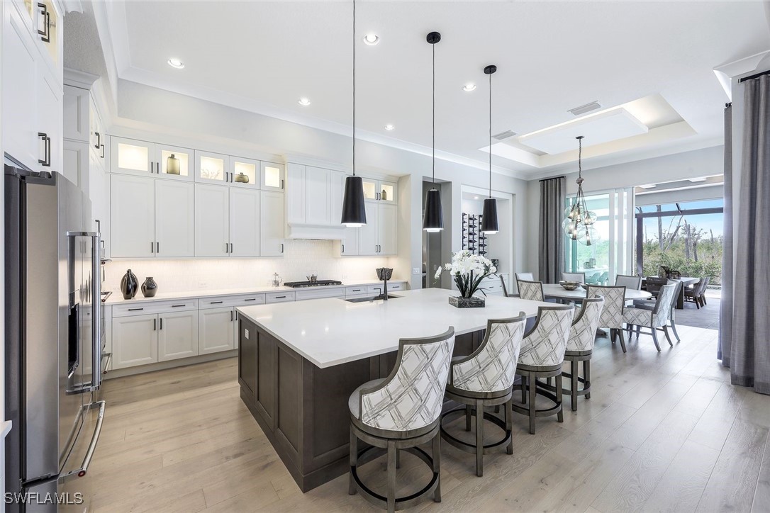 8903 Nevis Way Naples, FL 34112 - Photo 5 of 36 a large kitchen with a table and chairs