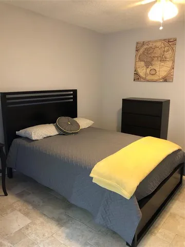 a bedroom with a bed and a lamp