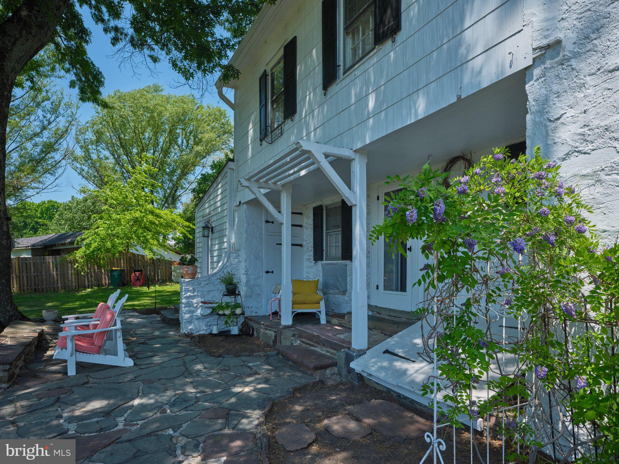 765 Swamp Road Newtown, PA 18940 - Photo 26 of 37 a view of brick house with a yard and plants