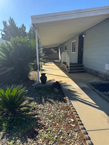 a view of a balcony with yard