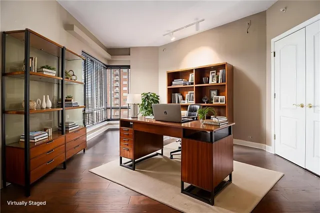 a view of a workspace with furniture and window