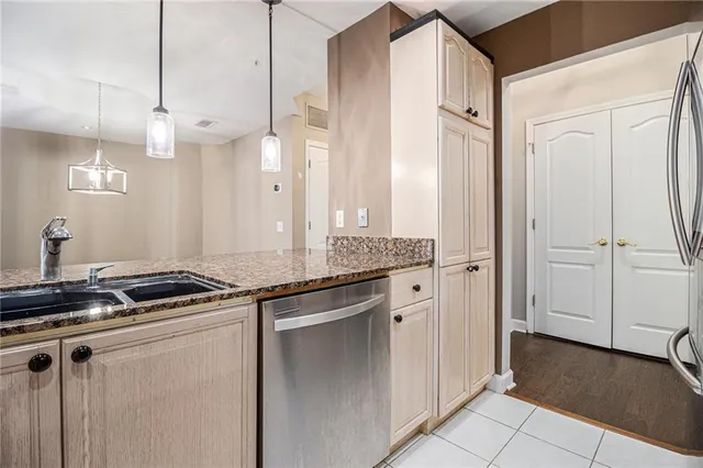 a kitchen with granite countertop a sink and a refrigerator