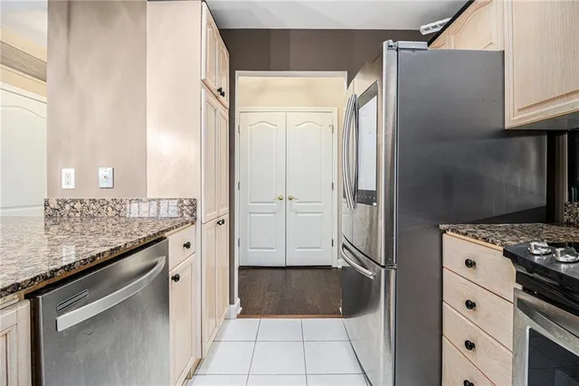 a kitchen with granite countertop a refrigerator and a stove