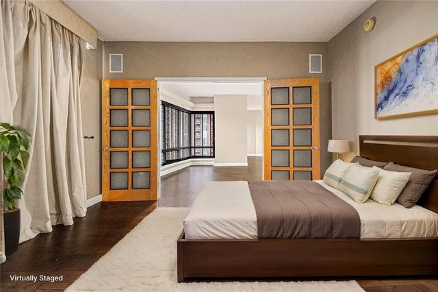 a bedroom with a large bed and a large window