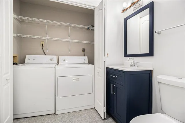 a bathroom with a sink toilet vanity and mirror