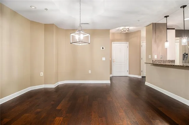 a view of a kitchen with wooden floor and kitchen space