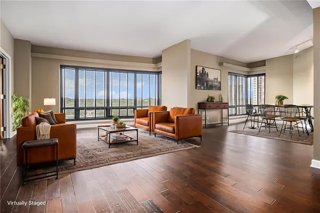 a living room with furniture and wooden floor