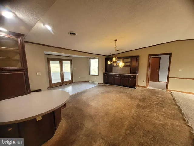 a large room with a large window and chandelier