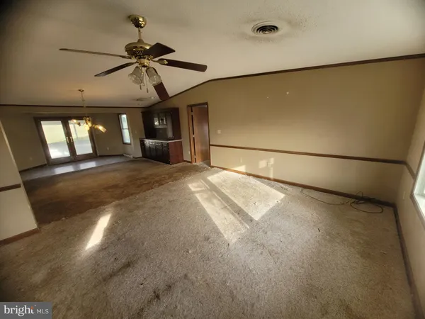 a view of a livingroom with a ceiling fan and window