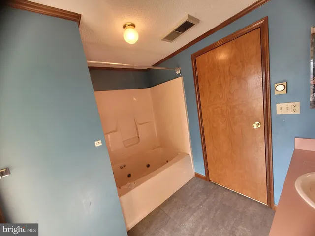 a bathroom with a glass shower door