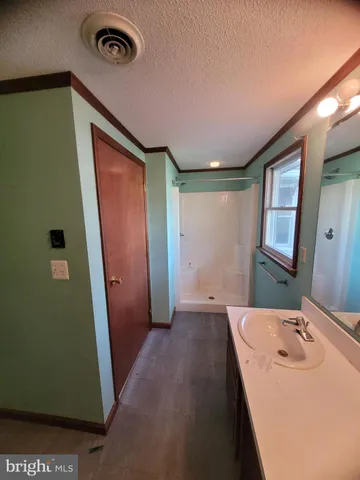 a view of room with a mirror and a vanity